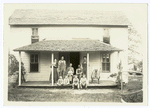 Farm family on the front porch of their home