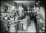 George Bruce interior views, children visiting circulation room, no children's room, children's books on front shelves, east wall