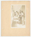 Men gathered around book cart in hall