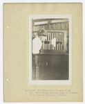 Immigrant boy inspecting treasures of New York Public Library Loan collection, Ellis Island Hospital Library