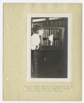 Immigrant boy inspecting treasures of New York Public Library Loan collection, Ellis Island Hospital Library