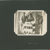 Men at Ellis Island with library book cart