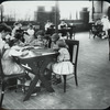 Girls doing embroidery as woman reads to them, Columbus roof