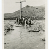 Transcontinental telephone line of the A.T. & T. Co. : putting up a pole in a salt sink, near Stone House, Nev., 60 miles west of Winnemucca, 5-5-14.
