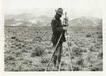Transcontinental telephone line of the A.T. & T. Co. : setting up the transit to measure the angle at the point of intersection which closed the survey in Nevada