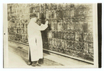 Man changing stock quotes on a chalk board