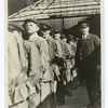 Lining up of porters before the train arrives, with an American Express interpreter "on the job" immediately behind them.