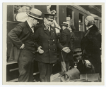 Interpreter parleys with the passenger regarding his luggage.