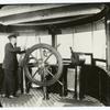 Man at the wheel of a ship
