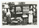 Parcel post carrier loading his truck.