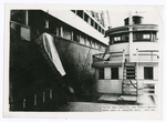 Harbor boat service, New York. Canvas chute used to transfer mail. Note bag.