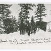 Rural mail truck stuck in snow in Uintah Mountains, Utah.