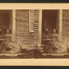 Portrait of an unidentified couple sitting in the doorway of a house, Casco Bay, Maine.