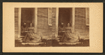 Portrait of an unidentified couple sitting in the doorway of a house, Casco Bay, Maine.