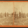View of men in ceremonial dress firing a cannon.]