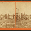 View of men in ceremonial dress firing a cannon.