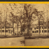Horse-drawn carriage in front of a house.