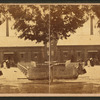 Ladies  standing at the front of a building.