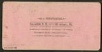 A couple under the umbrella posing against a background of the beach.