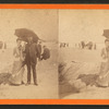 A couple under the umbrella posing against a background of the beach.