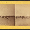 People on the seashore (some in the carriages) watching sailboats.
