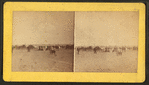 People on the seashore (some in the carriages) watching sailboats.