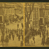 View of parade of men on horses and a marching band.