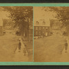 View showing dwelings and streets of Norway with a boy and girl in foreground.