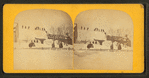 A winter view in Eastport showing people waving from the top of a snow-covered building.