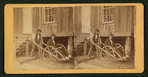 Man seated in a wooden wheelchair