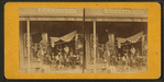 A general store with a group posed on the porch.