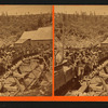 Group portrait of men posed on cars of mine railroad.