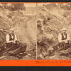 Primitive mining, the old rocker. C.E. Watkins posing as miner.
