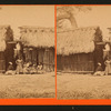 Family posing in front of thier hut.