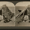 Navajos in front of their dwelling