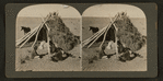Navajos in front of their dwelling
