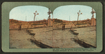 The earthquake ruptured pavement and fire wrecked mansions on Van Ness Ave., San Francisco.