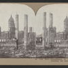 City Hall, Photographer in foreground. Tall brick chimneys left standing.