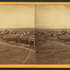 General view of East Denver and distant view of Rocky Mountains.