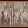 View of a garland-draped church interior with the pastor in the pulpit.