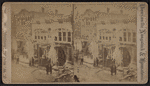 Men in street looking at scene of fire and ice on trees