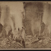 Men looking at smoking ruins after a fire