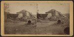 View of a collapsed barn with a haystack.