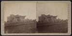 View of a damaged house with collapsed roof.