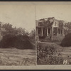 View of a house with no roof and downed trees around.]