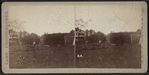 View of farmers rebuilding a haystack.