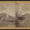View of a collapsed barn with a haystack.