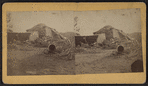 View of a collapsed barn with a haystack.