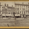 Commercial street with printer, insurance company, and hotel.]