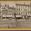 Commercial street with printer, insurance company, and hotel.